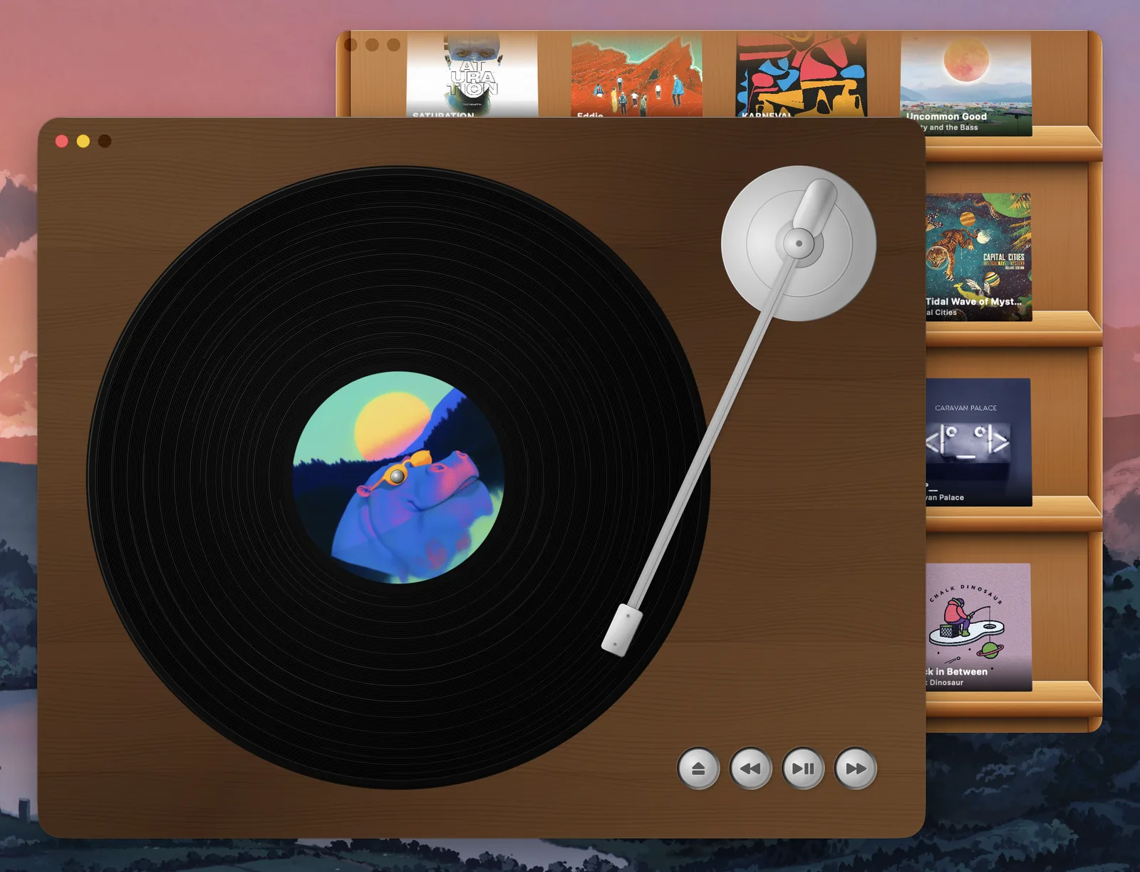 The turntable in front of a wooden shelf of album covers.
