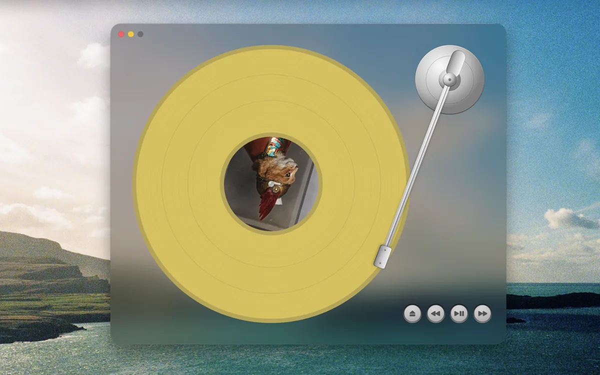 A frosted glass turntable with a yellow record and silver controls.